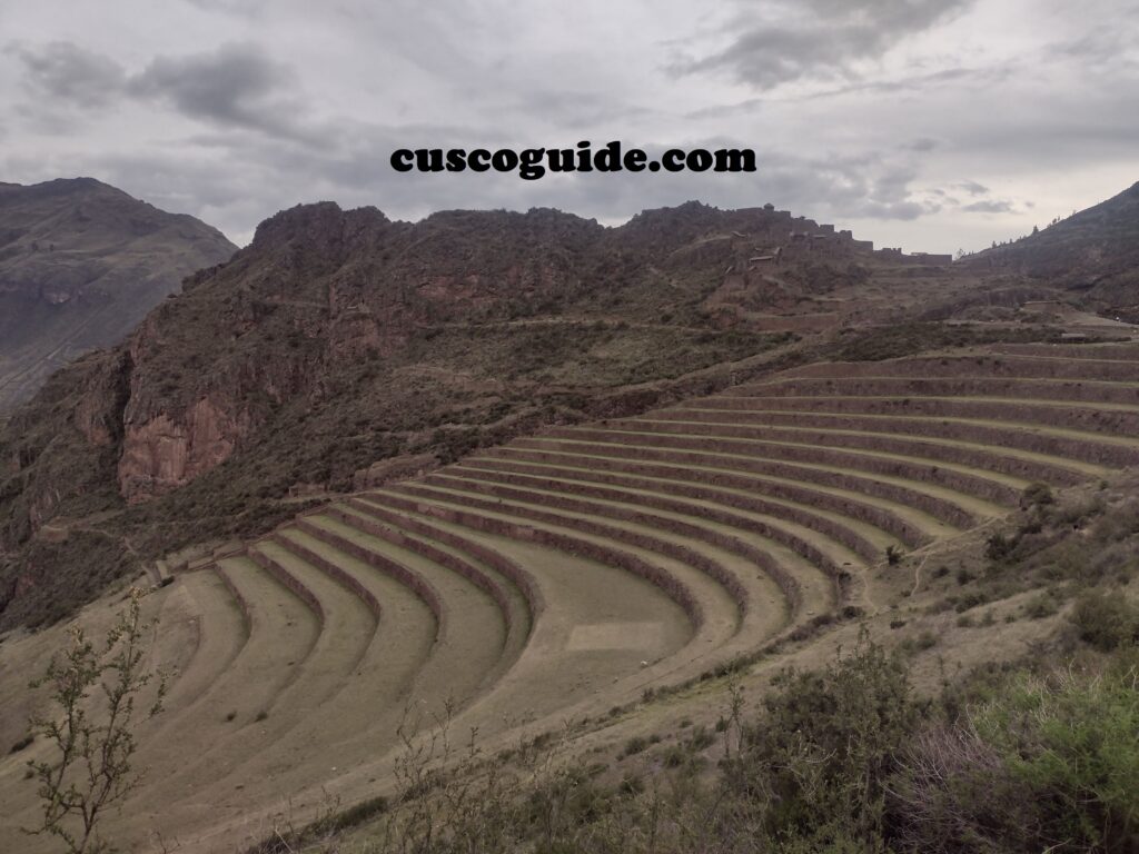 The agricultural terraces of Pisac, an Inca archaeological site in Peru’s Sacred Valley, surrounded by stunning mountain views.