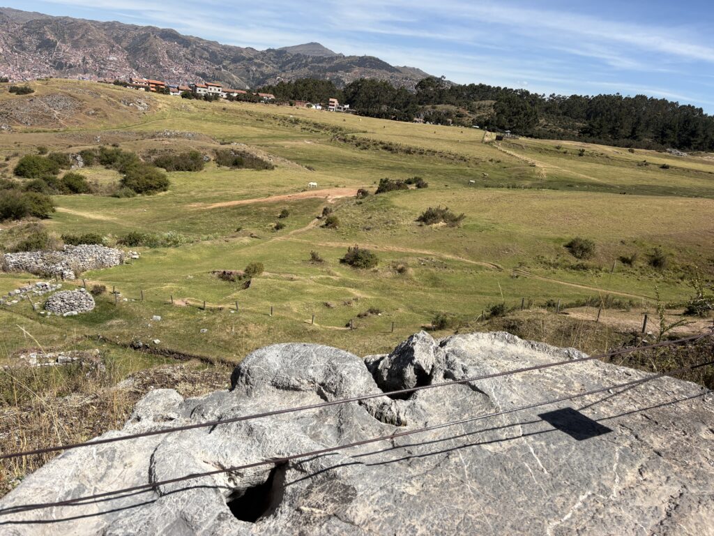 Inca sacred animals puma, snake, and condor carved into a stone at the Moon Temple in Cusco, Peru